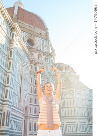 Portrait of happy young woman rejoicing in front of cattedrale d 14790668