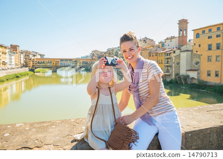 Mother and baby girl taking photo while standing on bridge overl Mother and baby girl taking photo while standing on bridge overl 14790713