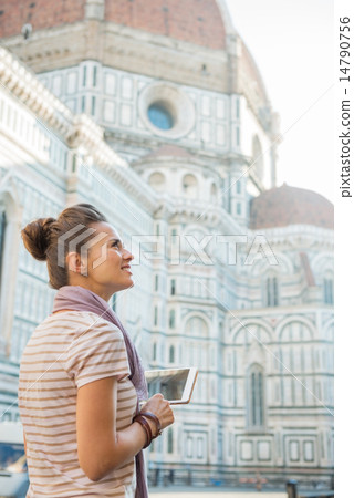 Happy young woman with tablet pc in front of cattedrale di santa 14790756