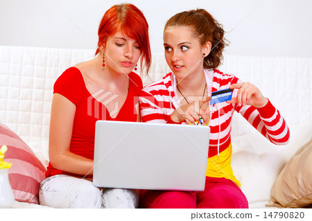 Two pretty girlfriends shopping in net using credit card 14790820
