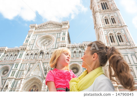 Happy mother and baby girl in front of duomo in florence, italy 14790845