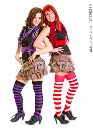 Two happy young girlfriends standing back to back. Two happy young girlfriends standing back to back. 14790880