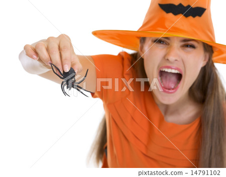 Woman in Halloween hat scaring with spider Woman in Halloween hat scaring with spider 14791102