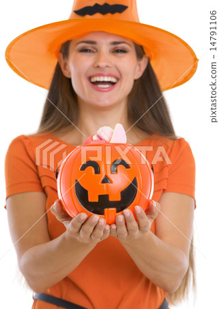 Closeup on Halloween bucket with sweets in woman hands Closeup on Halloween bucket with sweets in woman hands 14791106