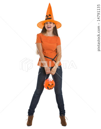 Happy woman holding Halloween bucket with sweets Happy woman holding Halloween bucket with sweets 14791135