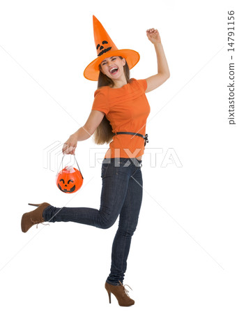 Full length portrait of happy woman holding Halloween bucket Full length portrait of happy woman holding Halloween bucket 14791156