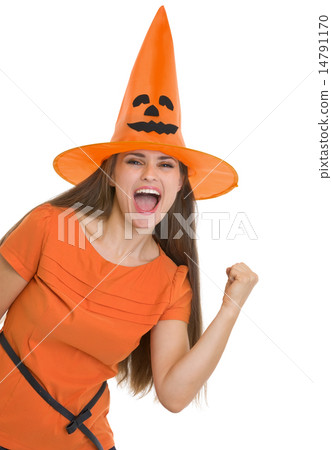 Happy young woman in Halloween hat showing yes gesture Happy young woman in Halloween hat showing yes gesture 14791170