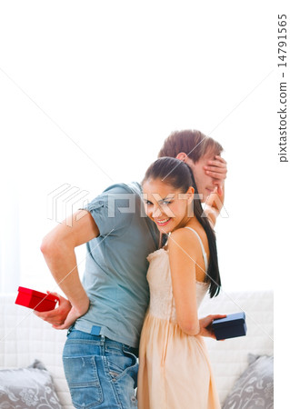 Young woman covering eyes of her curious boyfriend Young woman covering eyes of her curious boyfriend 14791565