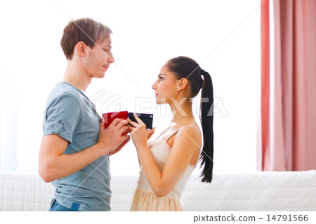 Romantic couple exchanging gifts Romantic couple exchanging gifts 14791566
