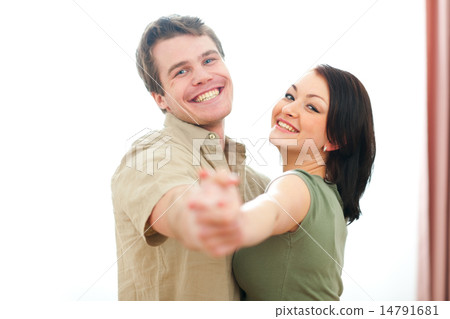 Smiling young couple dancing at home 14791681
