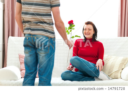 Young man presenting red rose to her girlfriend 14791728