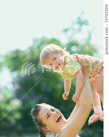 Smiling mother rising baby Smiling mother rising baby 14791809