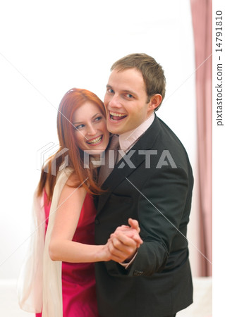 Formally dressed happy couple having fun dancing Formally dressed happy couple having fun dancing 14791810