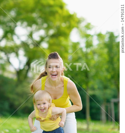 Portrait of happy mother and baby girl in park Portrait of happy mother and baby girl in park 14791811