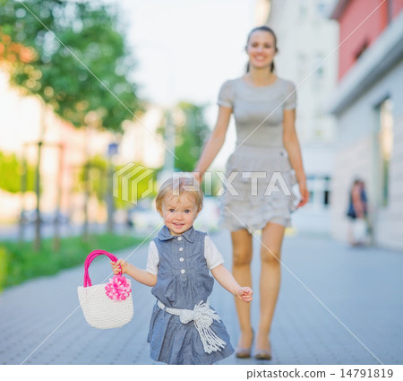 Happy baby walking with mom in city Happy baby walking with mom in city 14791819