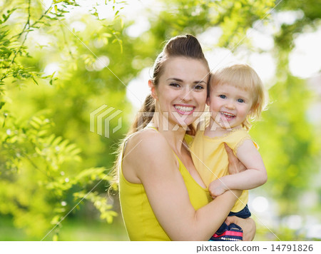 Portrait of smiling mother and baby girl outdoors Portrait of smiling mother and baby girl outdoors 14791826