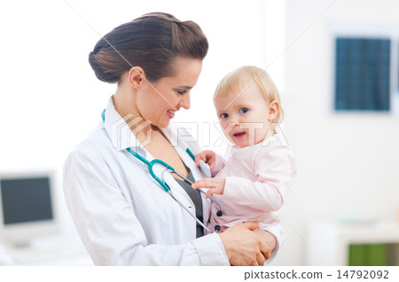 Pediatrician doctor with baby on examination Pediatrician doctor with baby on examination 14792092