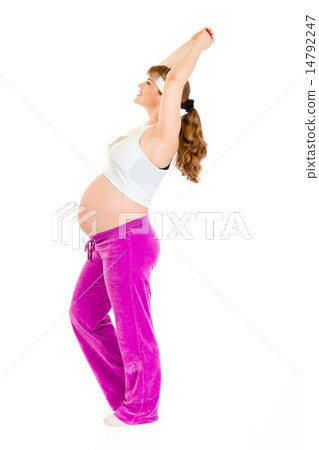 Smiling beautiful pregnant female doing fitness exercises. 14792247