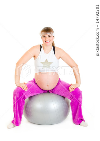 Smiling beautiful pregnant female doing exercises on fitness ball. 14792281