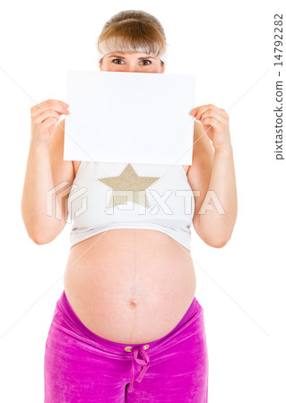 Pregnant woman holding empty white paper in front of her face. 14792282