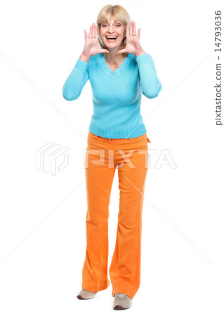 Happy middle age woman shouting through megaphone shaped hands 14793036