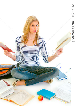 Shocked teen girl sitting on floor with books and preparing for exams. 14793165