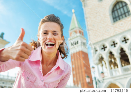 Happy young woman against campanile di san marco showing thumbs 14793346