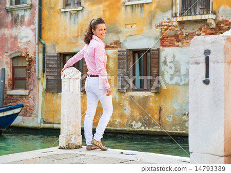 Happy young woman standing on street in venice, italy 14793389