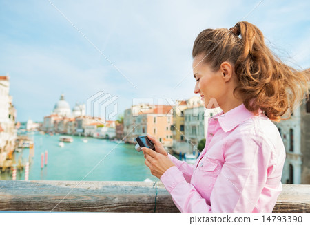 Young woman standing on bridge with grand canal view in venice, 14793390