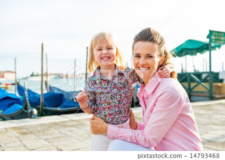 Portrait of happy mother and baby on grand canal embankment in v 14793468