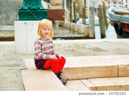 Baby girl sitting on embankment in venice, italy 14793583