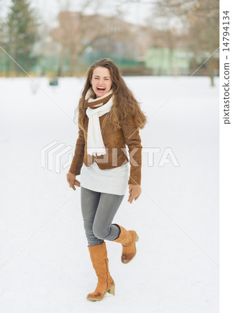 Happy young woman enjoying winter in park Happy young woman enjoying winter in park 14794134