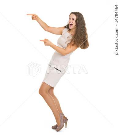 Full length portrait of happy young woman pointing on copy space 14794464