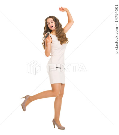 Full length portrait of happy young woman singing in microphone Full length portrait of happy young woman singing in microphone 14794501