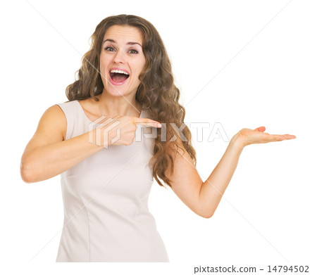 Smiling young woman presenting something on empty palm Smiling young woman presenting something on empty palm 14794502