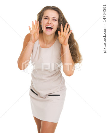 Happy young woman shouting through megaphone shaped hands Happy young woman shouting through megaphone shaped hands 14794591