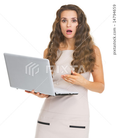 Surprised young woman pointing on laptop Surprised young woman pointing on laptop 14794659