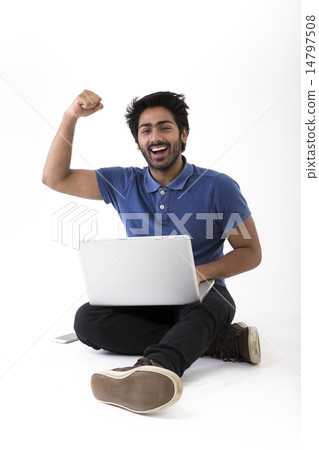Happy Indian man using a laptop PC and cheering. 14797508