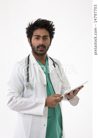 Male Indian doctor wearing a white coat and stethoscope. 14797703