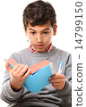Boy reading a book 14799150