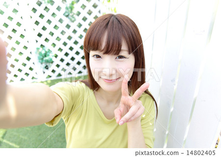 Woman taking a selfie Woman taking a selfie 14802405