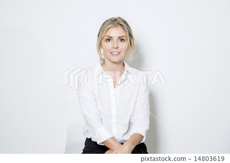 Smiling businesswoman sitting  14803619