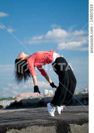 woman dancing hip hop over blue sky woman dancing hip hop over blue sky 14807039