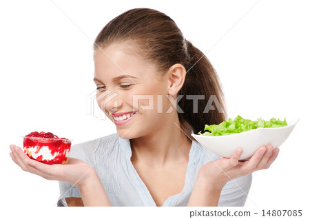 Pretty young woman choice salad or cake. Isolated 14807085