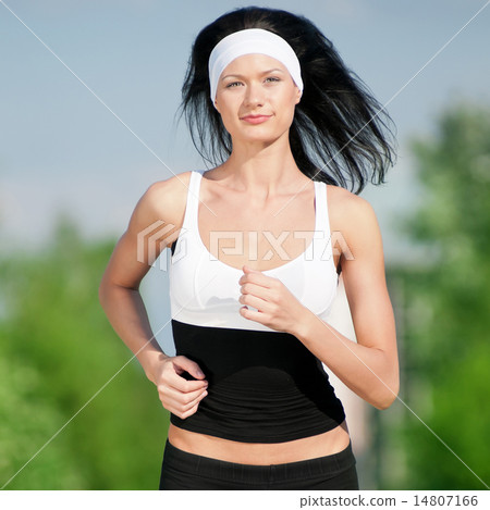 Woman running in green park Woman running in green park 14807166