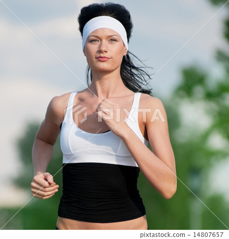 Woman running in green park Woman running in green park 14807657
