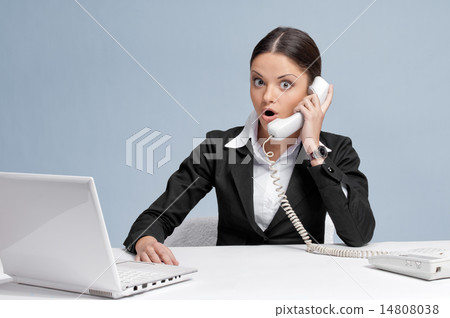 Casual business woman in office talking by phone 14808038