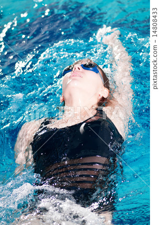 Swimmer in swim meet doing backstroke Swimmer in swim meet doing backstroke 14808433