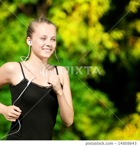 Young woman running in green park Young woman running in green park 14808643