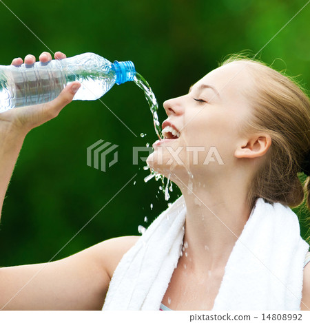 Woman drinking water after exercise 14808992